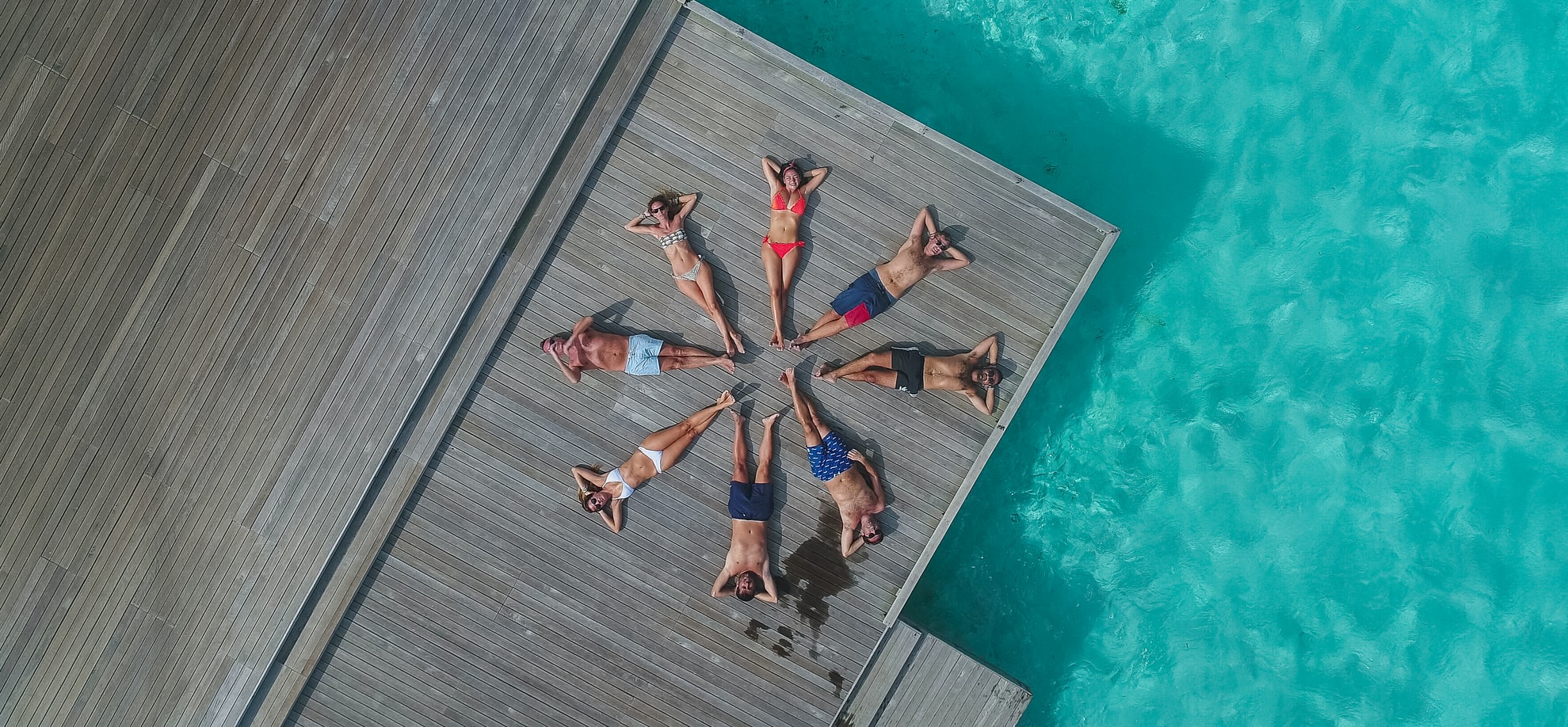 people lying on a deck